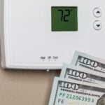 The thermostat was set at 72 degrees, and 3 $100 bills were in front of it.