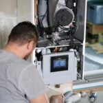 ac technician working on an ac unit